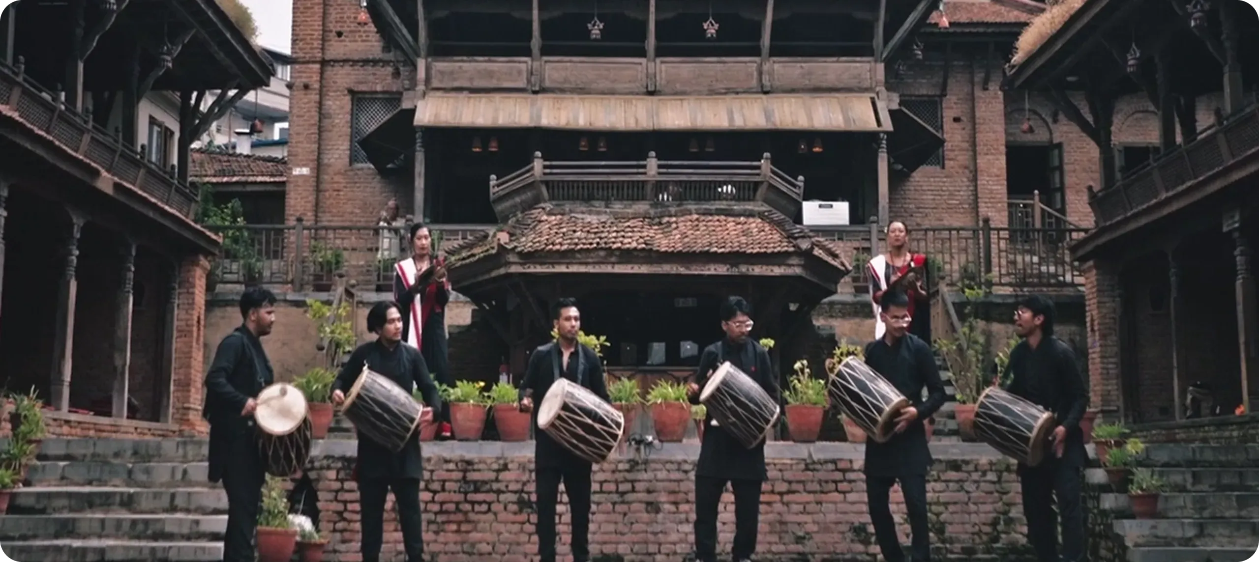 Nepali musicians performing in a traditional courtyard